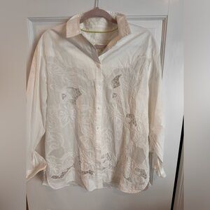 White blouse with intricate lace like detail from Anthropologie